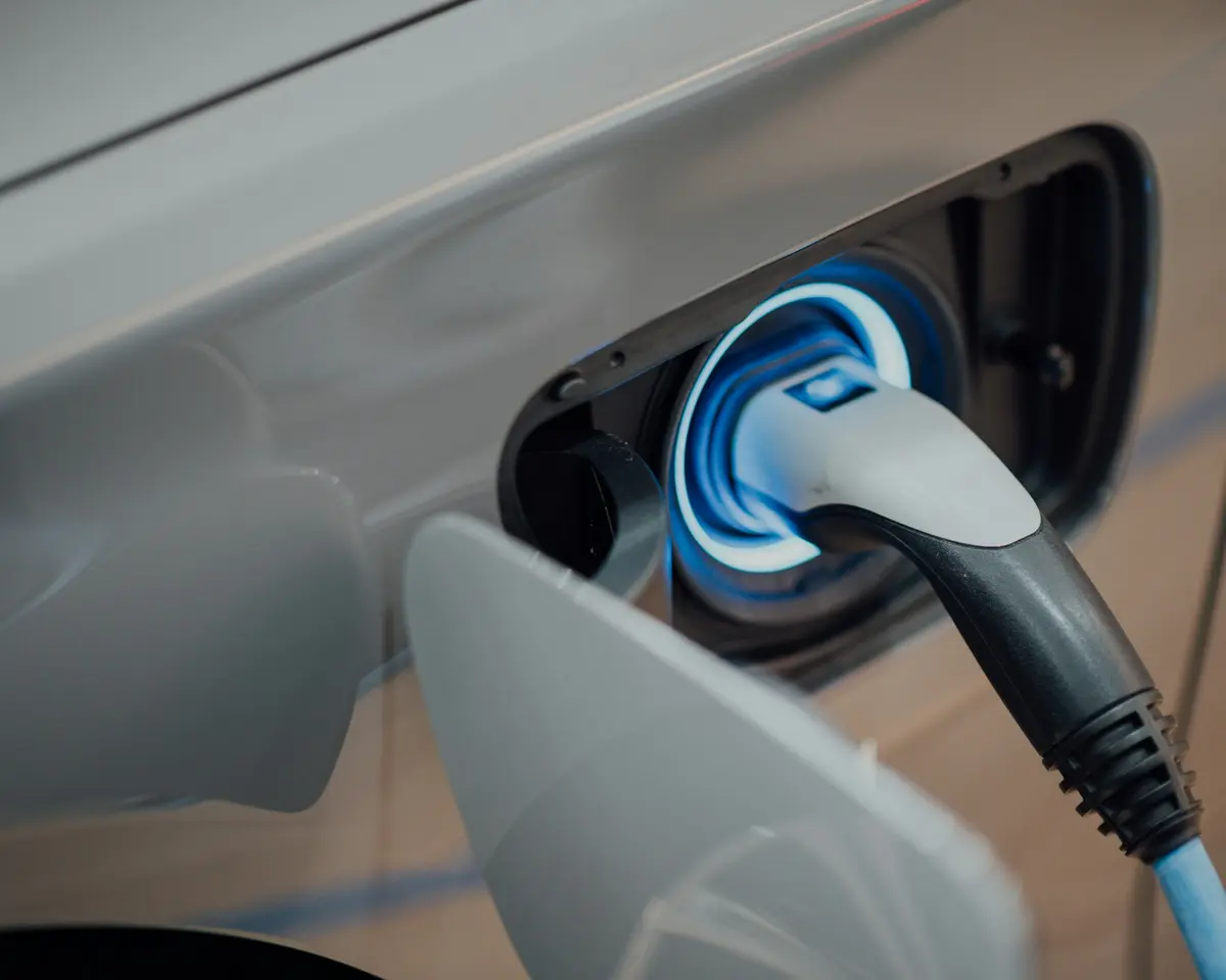 A charging cable plugged into an electric car