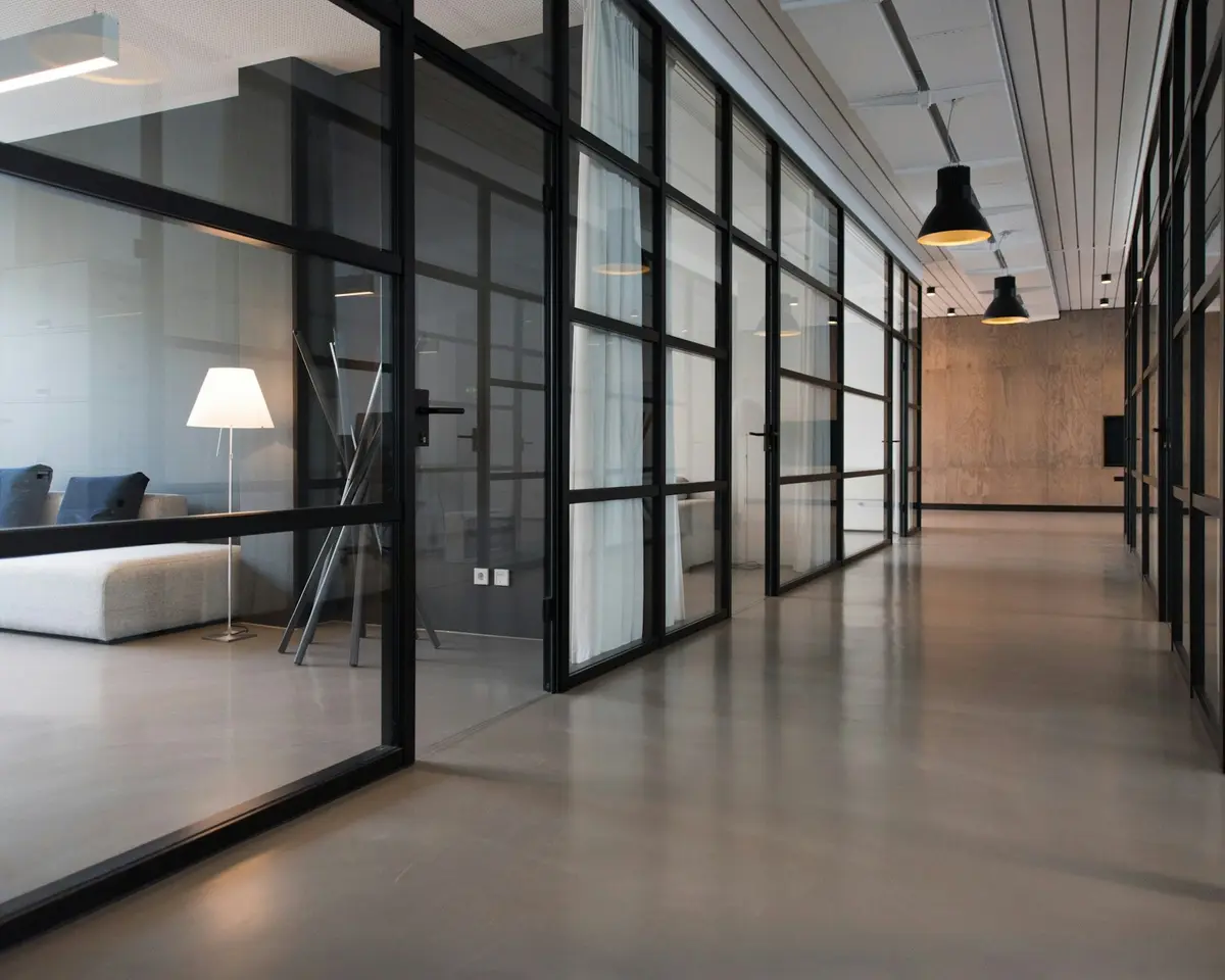 A bright corridor with glass walls in an office building